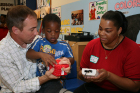 Dr. Terry Foust helps a Head Start provider conduct her first OAE screening