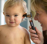 a woman checking a baby's hearing