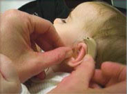 a baby getting her hearing tested