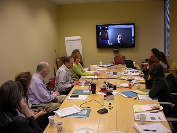 a group of TI professionals discussing TI options, a tanberg monitor displaying a TI test session